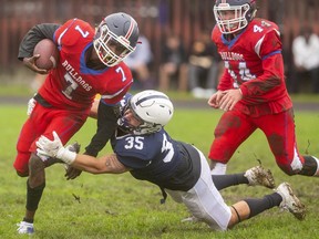 Christian Thomson of Catholic Central high school tackles St. Andre Bessette's Nicholas Myatt in a TVRA London District senior game at CCH on Thursday, Oct. 21, 2021. CCH won 37-7. (Mike Hensen/The London Free Press)
