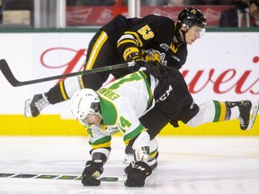London Knights captain Luke Evangelista got a rough ride from the Sarnia Sting early, being checked by Cameron Supryka but got his revenge with a tying goal late in the first period to make it 1-1 at Budweiser Gardens in London, Ont.  Photograph taken on Friday October 29, 2021. (Mike Hensen/The London Free Press)