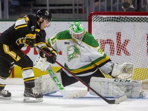 London Knights goalie Brett Brochu makes a save on Ben Lalkin of the Sarnia Sting in a game Oct. 29, 2021, at Budweiser Gardens in London. The Ontario Hockey League announced Fridaythe Knights have been put in COVID-19 protocols, forcing the postponement of their game on New Year's Day in Erie. (Mike Hensen/The London Free Press)