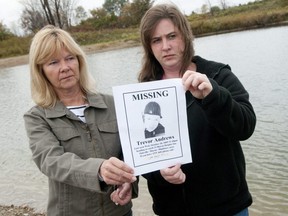 Debbie Harding, left, and her daughter Kelly Andrews hold a poster showing a picture of Trever Andrews, their missing son and brother, near a set of ponds northeast of London where they believed his body may be as they searched on Thursday, October 14th, 2010. Trever Andrews disappeared on October 28th, 2009, believed to be catching a bus near his London home. He has not been seen or heard from since. (Free Press file photo)