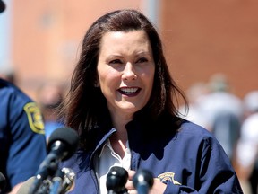 Michigan Governor Gretchen Whitmer addresses the media in downtown Midland, Michigan, May 20, 2020.