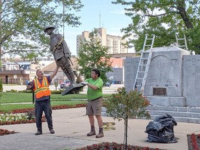 A bronze statue of Canadian soldier known as Tommy is removed from the Veterans Park cenotaph in Sarnia on June 28, 2021, to be shipped off for repairs. Officials discovered two months earlier the soldier's rifle had been stolen. The refurbished statue is being reinstalled this week. (Tom Klaasen photo)
