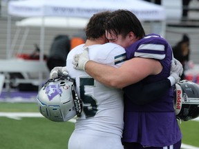 Western Mustangs player Max Von Muehldorfer, right, embraces his older brother, St. Francis Xavier’s Ben Von Muehldorfer, after Western’s 61-6 win in the Mitchell Bowl, Canada’s national university football semifinal, in London on Saturday Nov. 27, 2021. DALE CARRUTHERS/THE LONDON FREE PRESS