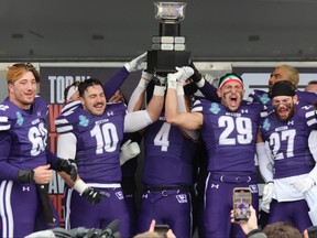 Western Mustangs players celebrate with the Mitchell Bowl after defeating St. Francis Xavier 61-6 on Saturday Nov. 27, 2021, at Western Alumni Stadium. The Mustangs will face the Saskatchewan Huskies in the Vanier Cup on Saturday in Quebec City. DALE CARRUTHERS/THE LONDON FREE PRESS