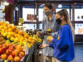 Customers shop for fruit at Ponesse Foods at St. Lawrence Market in Toronto on Sept. 15, 2021.