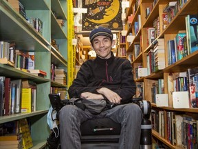 Daniel Harvey sits among the inventory at City Lights Bookshop in London on Tuesday Nov. 2, 2021. Harvey, his wife Jennifer Brewe and their friend Drew Nelles become the new owners of the store at month's end. (Derek Ruttan/The London Free Press)