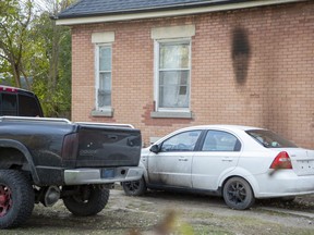 Fire and/or smoke damage is visible on a car door and house wall at the corner or Price Street and Hamilton Road in London, Ont. on Monday. (Derek Ruttan/The London Free Press)