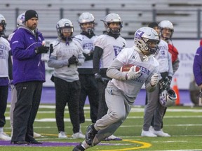 Western Mustangs running back Keon Edwards runs with the ball during team practice in London. (Derek Ruttan/The London Free Press)