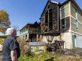 Shawn Davis of the London Fire Department surveys the damage to the clubhouse at the city-owned River Road golf club, which was struck by an arsonist. The blaze did $1 million in damage. The golf course was to become the site of an Indigenous-led winter homeless shelter. Photo taken Nov. 7, 2021. (Mike Hensen/The London Free Press)