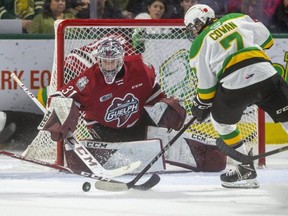 Jack Harper of the Guelph Storm knocks the puck away from Easton Cowan of the London Knights in front of Storm goalie Owen Bennett on Tuesday Nov. 9, 2021, at Budweiser Gardens. The Storm handed the Knights their second straight loss after nine wins to start the season. The Knights look to get back in the win column Friday when they host the Soo Greyhounds. (Mike Hensen/The London Free Press)