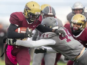 Nawaz Oyewale of Banting gets wrapped up by Marcus Robinson of South during a Thames Valley Central semifinal between the South Lions and the Banting Broncos at City Wide Fields in London on Friday Nov. 19, 2021. 
South won 50-13 and will face Laurier in the Central final next Friday.
(Mike Hensen/The London Free Press)