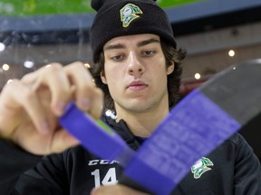 London Knights captain Luke Evangelista tapes his stick with purple tape for the Shine the Light  on Woman Abuse campaign before Friday's game at Budweiser Gardens against the visiting Sarnia Sting. (Mike Hensen/The London Free Press)