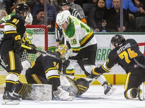 London Knights forward Colton Smith tries to jam a loose puck under Sarnia Sting goalie Anson Thornton as Ethan Ritchie and Max Namestnikov move in during the first period at Budweiser Gardens in London. Sarnia won, 4-2. Photo taken Friday Nov. 19, 2021. Mike Hensen