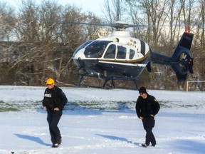 Staff Sgt. Trevor Poole, head of the search and recovery unit for the London police, and an OPP officer walk away from an OPP helicopter after taking part in a search for a person who entered the Thames River in the Wharncliffe and Riverside Drive area on Saturday and hasn't been seen since. Poole said they searched as far away as Komoka on Monday with the helicopter, adding that the OPP had their underwater search and recovery teams also involved. The search was called off a day later. Photo taken on Monday Nov 29, 2021.
(Mike Hensen/The London Free Press)