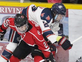 Listowel Cyclones Rylan Bowers, far left, and Brendan Koops battle. Terry Bridge/Postmedia Network file photo