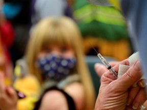 A syringe is seen as a child receives a dose of the Pfizer-BioNTech coronavirus disease (COVID-19) vaccine at Smoketown Family Wellness Center in Louisville, Kentucky, U.S., November 8, 2021. REUTERS/Jon Cherry