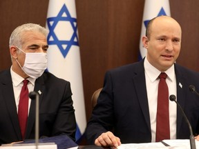 Israel's Prime Minister Naftali Bennett speaks next to Foreign Minister Yair Lapid during a weekly cabinet meeting in Jerusalem earlier this week.