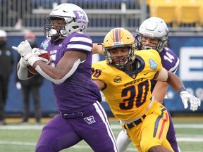 Western Mustangs star Keon Edwards runs for a touchdown past Queen's Gaels rival Josh McBain during in the Ontario University Athletics football final, the Yates Cup, at Richardson Stadium in Kingston on Saturday Nov. 20, 2021. The Mustangs won, 29-0. PHOTO BY IAN MACALPINE /The Kingston Whig-Standard