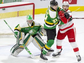 London Knights defenceman Kirill Steklov battles Soo Greyhounds winger Tye Kartye in front of Knights goaltender Brett Brochu in a game Feb. 10, 2021, at Budweiser Gardens in London. The Knights announced Friday that Steklov is rejoining the team after playing in the KHL in Russia and with the Russian junior team at the abbreviated world championship. (London Free Press file photo)