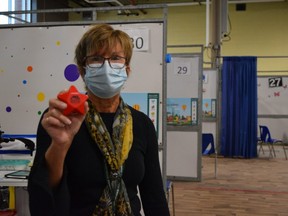 Tracey Gordon, senior manager of the Middlesex-London Health Unit’s COVID-19 vaccine team, shows off one of the stress stars handed out to kids getting their first doses at its Western Fair District Agriplex clinic. The clinic has administered more than 3,500 doses to children five- to 11-years-old in the first week of the pediatric vaccine rollout. (Jennifer Bieman/The London Free Press)