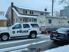 Sarnia police vehicles, including a command center, are located along Watson Street near London Road, while criminal and forensic officers are investigating a death on Wednesday. Another death investigation is underway in Enniskillen Township, where human remains were found on the Crooked Line. (Paul Morden / Postmedia Network)
