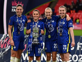 Midfielder Jessie Fleming of London, Ont., second left, celebrates Chelsea's 3-0 win over Arsenal in the 2021 Women's FA Cup final with teammates Melanie Leupolz, left, Pernille Harder and Niamh Charles at Wembley Stadium in London Dec. 5. (Ben Stanshall/Getty Images)