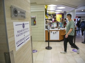 People show proof of vaccination to enter the Mustang Lounge inside the university community centre at Western University in London on Thursday, Dec. 9, 2021. (Derek Ruttan/The London Free Press)