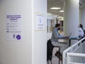 Signs about Western University's COVID-19 protocols are posted inside the university community centre on Thursday Dec. 9, 2021. Western said Thursday  in-person exams will begin Friday as planned, but some staff will begin working from home on Monday to decrease the number of people on campus as COVID-19 cases increase in the London region. (Derek Ruttan/The London Free Press)