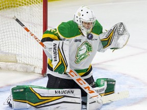 London Knights goalie Owen Flores makes a save during the first period of their OHL hockey game against the Windsor Spitfires at Budweiser Gardens in London on Friday Dec. 10, 2021.  (Derek Ruttan/The London Free Press)