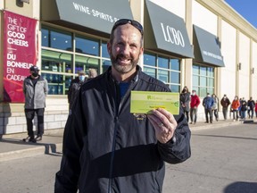 Pete McIntosh was happy to pick up a COVID-19 antigen rapid test kit Friday at the LCBO on Wonderland Road at Southdale Road in London. The kits are available at six stores in London, one in Sarnia and one in Woodstock. (Derek Ruttan/The London Free Press)