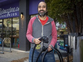 Heenal Rajani says an electric vehicle charger he had installed at Reimagine Co. Groceries in London is part of the store's mission to raise awareness among customers of more environmentally friendly ways to live. Derek Ruttan/The London Free Press