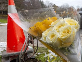 A bouquet of flowers is placed at the site of a crash Tuesday night on Riverside Drive in London where a woman, a female teenager and eight girls were hit by an SUV while walking. An eight-year-old girl later died. Members of the Girl Guides were among the injured. Photograph taken Wednesday Dec. 1, 2021.  Mike Hensen/The London Free Press