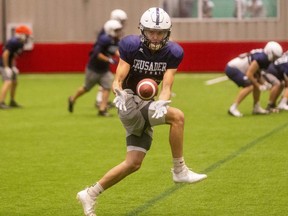 Ethan Wilkins collects a pass during Catholic Central's football practice at the BMO Centre on Wednesday Dec. 1, 2021. CCH will play in the junior and senior city championships on Friday. (Mike Hensen/The London Free Press)