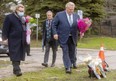 Ontario Premier Doug Ford and London Mayor Ed Holder lay flowers at the site where an eight-year-old girl was struck and killed by a motorist on Riverside Drive Tuesday evening in London. Photograph taken Wednesday, Dec. 1, 2021. (Mike Hensen/The London Free Press)