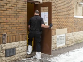 A London police investigator enters Wharncliffe Lodging at 256 Wharncliffe Rd. S. Thursday as police probe the death of Kenneth Wallis, 56, who was taken to hospital with serious injuries late Wednesday and later died. Robert Charnock, 40, is charged with second-degree murder in the city's 12th homicide of 2021. (Mike Hensen/The London Free Press)
