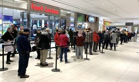 People wait in line to get a COVID-19 vaccine at a pop-up clinic on Masonville Place run by the Middlesex-London Health Unit on Wednesday.  Demand for booster shots 