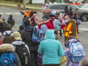 Principal Ken Overeem of Eagle Heights Public School helps out the crossing guard trying to keep the children crossing Oxford Street safe on Wednesday December 15, 2021. 
(Mike Hensen/The London Free Press)