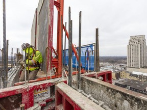 Casey Kemp of Ellis Don secures a climbing bracket (or work platform) into position to begin the next floor, 13 floors above 131 King Street as the York Development building will eventually stretch 31 stories with 266 apartments as well as commercial space right across from the Covent Garden Market and near Budweiser Gardens in London, Ont. Photograph taken on Tuesday December 21, 2021. (Mike Hensen/The London Free Press)