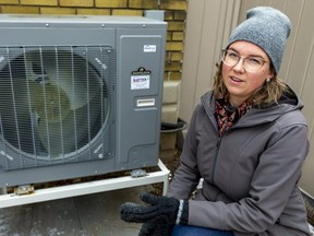 Skylar Franke, executive director of the London Environmental Network, shows a heat pump that helped bring her 100-year-old home to net zero greenhouse gas emissions. (Mike Hensen/The London Free Press)