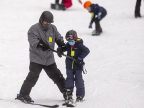 Brent Allen helps his son Turner Allen, 8, down the beginner slope at Boler Mountain. Outdoor activities are one way to keep boredom at bay in the lull between Christmas and New Year's. Photograph taken Thursday Dec. 23, 2021. (Mike Hensen/The London Free Press)