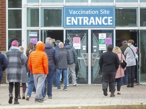 The Agriplex mass vaccination site opened at 11am Thursday with a small crowd of people waiting for their chance for a vaccination or booster. A sign on the door said anyone over 30 would be getting the Moderna vaccine rather than Pfizer due to a shortage.  (Mike Hensen/The London Free Press)