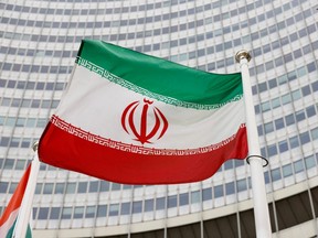FILE PHOTO: The Iranian flag waves in front of the International Atomic Energy Agency (IAEA) headquarters in Vienna, Austria May 23, 2021. REUTERS/Leonhard Foeger/File Photo
