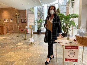 Theresa O’Leary was tasked with screening parishioners as they arrived for Christmas mass at St. Michael’s Catholic church on Cheapside Street in London. Photo taken on Dec. 25, 2021. Serena Marotta/The London Free Press