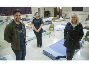 Joseph Lawrence, pastor of First-St. Andrews United Church on Queens Avenue, Sarah Campbell, executive director of Ark Aid Street Mission, and Debbie Kramers, the city of London's manager of co-ordinated informed response, show the overnight "resting spaces" set up in the basement of First-St. Andrews for people to come in out of the cold. The 40-bed shelter has been full each night since opening last month. (Mike Hensen/The London Free Press)