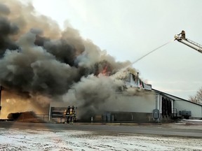 Owners of a Mitchell-area fruit and vegetable processing plant vowed to rebuild after their main building was destroyed in a Tuesday morning fire.