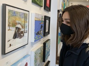 Abbiegale Morash, 17, checks out the art at Westland Gallery's Square Foot Show. (JOE BELANGER, The London Free Press)