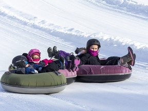 Ashley Shire, her two children, Ali Shire, 7, and Archer Shire, 4, as well as their friends, Blair Lamothe, 6, and Theo Lamothe, 4, whiz down a 180-metre tube slope Friday at the River Valley Winter Tube Slide in Perth South. Environment Canada is warning those engaging in outdoor activities this weekend to dress for colder than normal weather. (Derek Ruttan/The London Free Press)