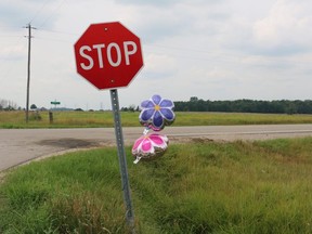 Two memorial flower balloons twirl in the wind around a stop sign at the intersection of Nairn Road and McEwan Drive following a crash on July 30, 2018, that killed Aleiya Hellowell-Hall, 7, and severely injured her mother. The driver of the pickup truck that collided with the car carrying the girl and her mother pleaded guilty Tuesday to careless driving causing death and careless driving causing bodily harm. (Free Press file photo)