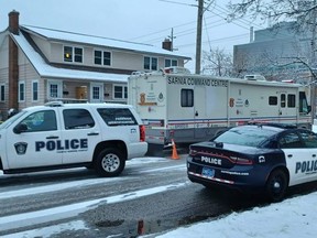 Sarnia police vehicles, including a command centre, line Watson Street near London Road as criminal and forensic officers investigate a death in late December 2021. A second death investigation began in Enniskillen Township after human remains were found Dec. 28. A 42-year-old Sarnia man is charged with two counts of second-degree murder. (Paul Morden/Postmedia Network)