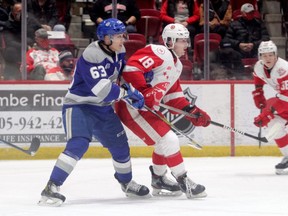 Sudbury Wolves defenceman Liam Ross, left, keeps close tabs on Soo Greyhounds forward Bryce McConnell-Barker at GFL Memorial Gardens in Sault Ste. Marie on Dec. 29, 2021. McConnell-Barker, a London Jr. Knights grad, is ranked 28th among North American skaters by the NHL Central Scouting Bureau. (Gordon Anderson/Postmedia Network)